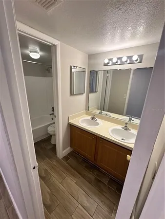 a bathroom with a double vanity sink and mirror