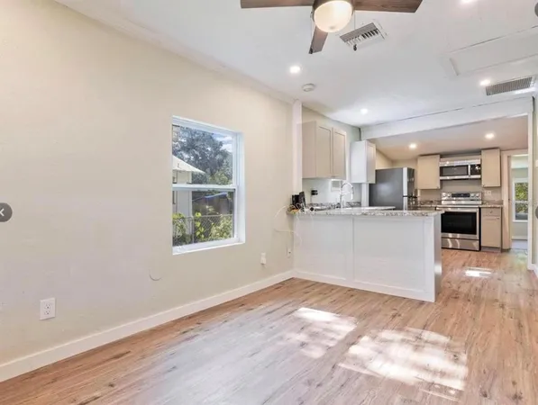 a view of a kitchen with microwave and cabinets