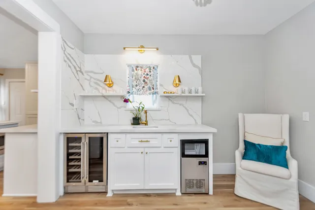 a kitchen with stainless steel appliances a stove and white cabinets
