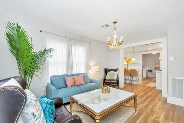 a living room with furniture and a chandelier