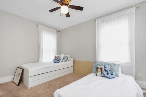 a bedroom with a large bed and a ceiling fan