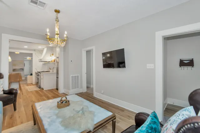 a living room with furniture and a chandelier