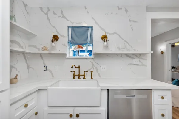 a kitchen with white cabinets and white appliances