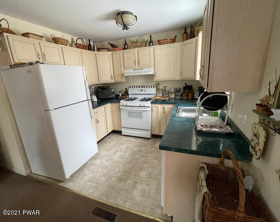184 Skyview Road Dingmans Ferry, PA 18328 - Photo 14 of 26 a kitchen with a refrigerator and a stove