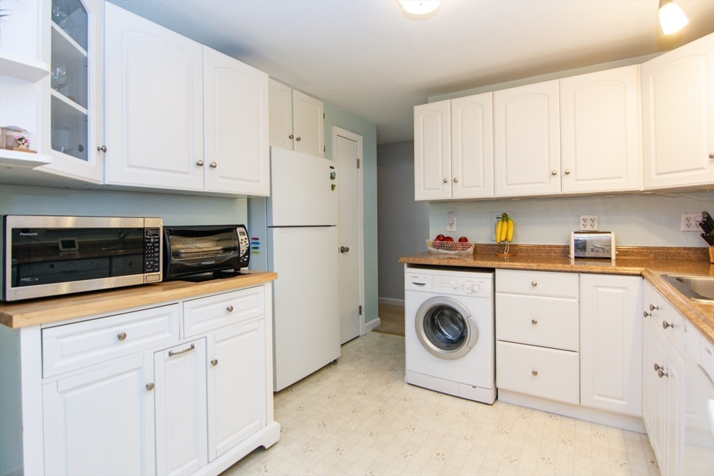 7 Sheffield Road Natick, MA 01760 - Photo 11 of 27 a kitchen with white cabinets and sink