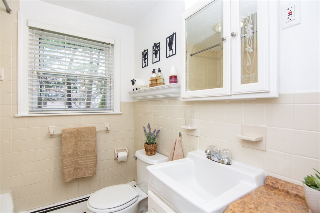 7 Sheffield Road Natick, MA 01760 - Photo 12 of 27 a bathroom with a sink a toilet and a window