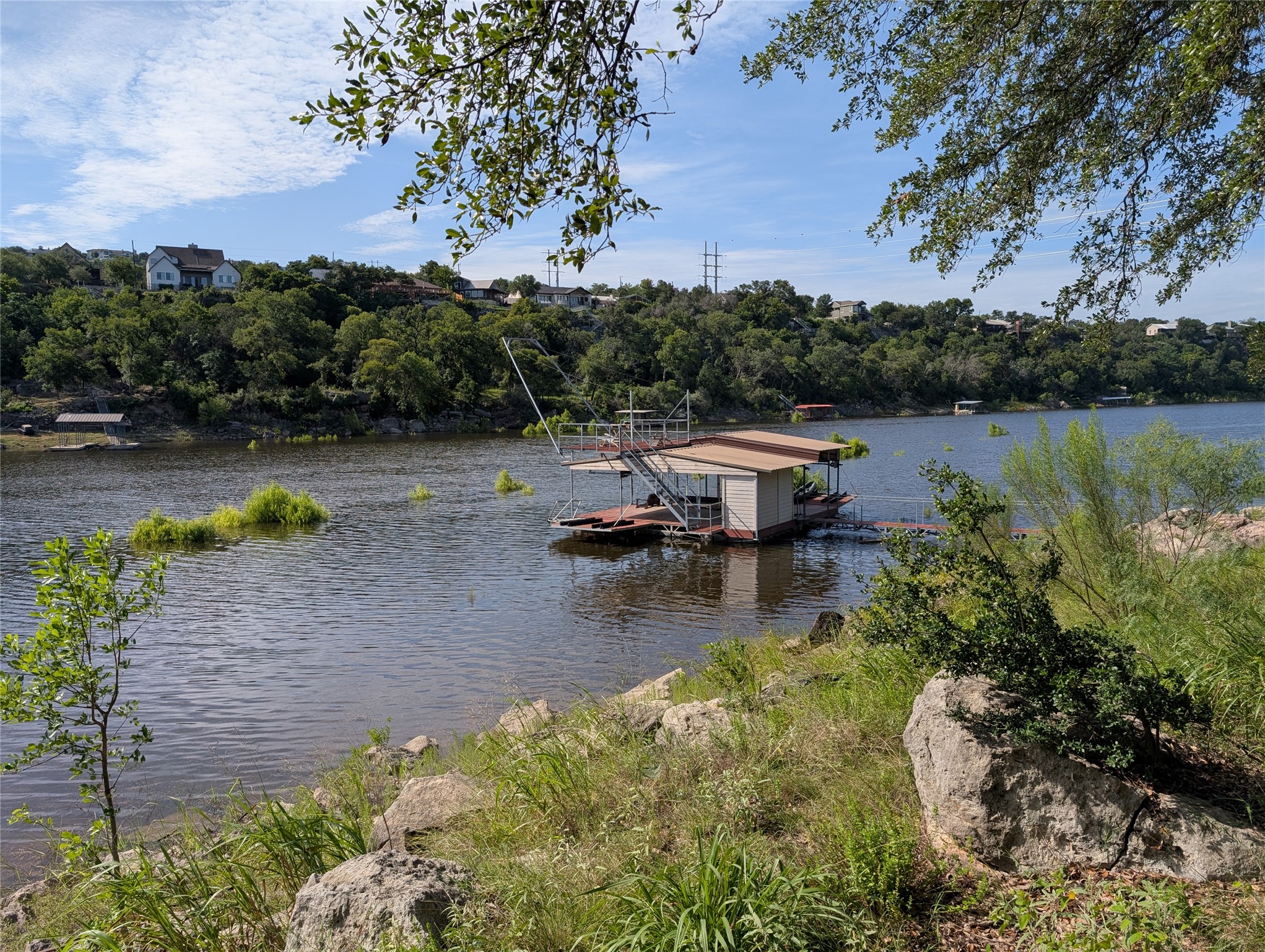 1909 Performer Road Spicewood, TX 78669 - Photo 4 of 19 a view of a lake with a yard