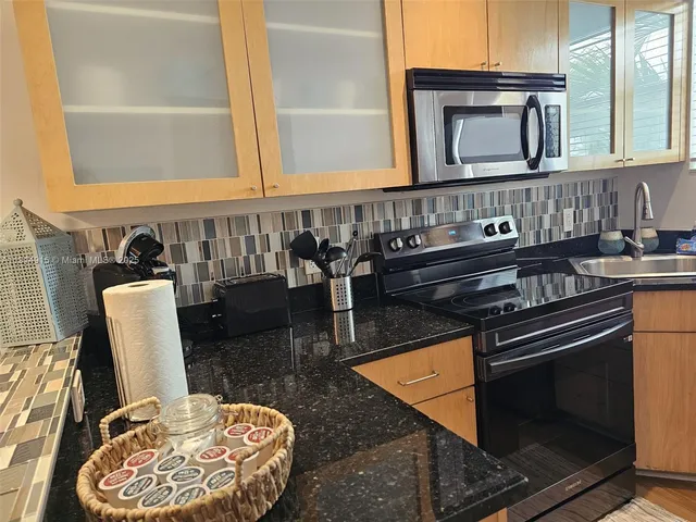 a kitchen with a stove and a microwave