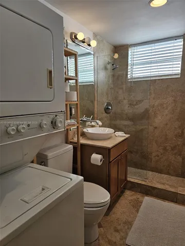 a bathroom with a sink toilet and mirror