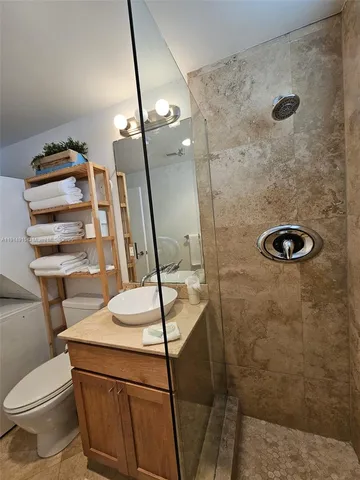 a bathroom with a sink toilet and shower