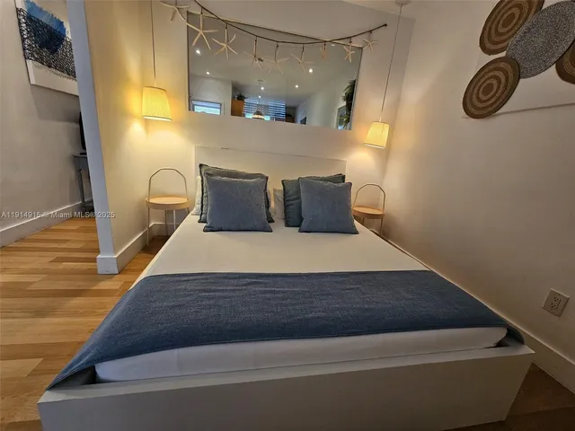 a room with a bed and painted walls