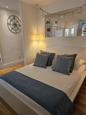a bedroom with a bed and a table in it