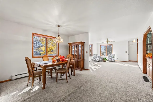 a dining room with furniture and window