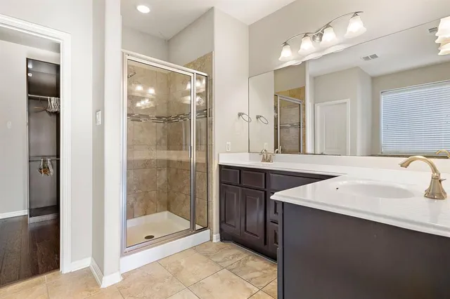 a bathroom with a tub sink and mirror