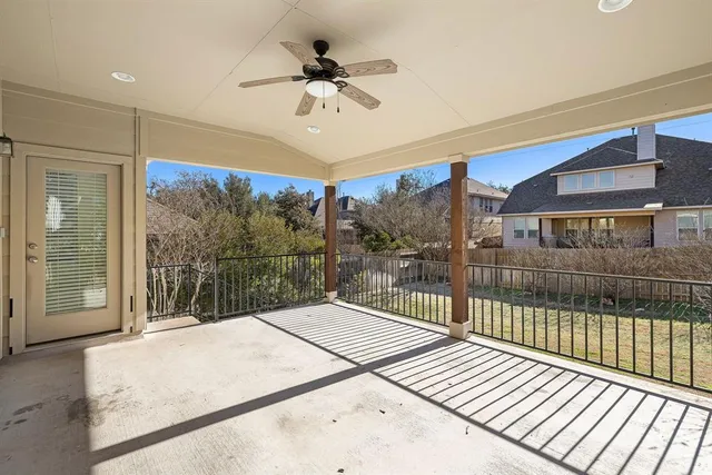 a front view of a house with a yard and potted plants