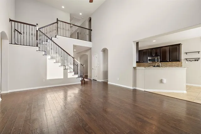 a view of a livingroom with wooden floor and furniture