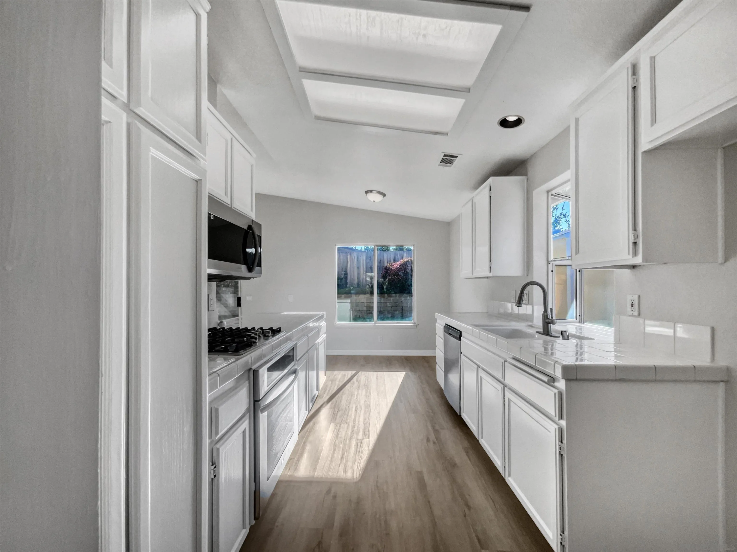 140 South Mercedes Road Fallbrook, CA 92028 - Photo 13 of 21 a kitchen with stainless steel appliances a sink stove and cabinets