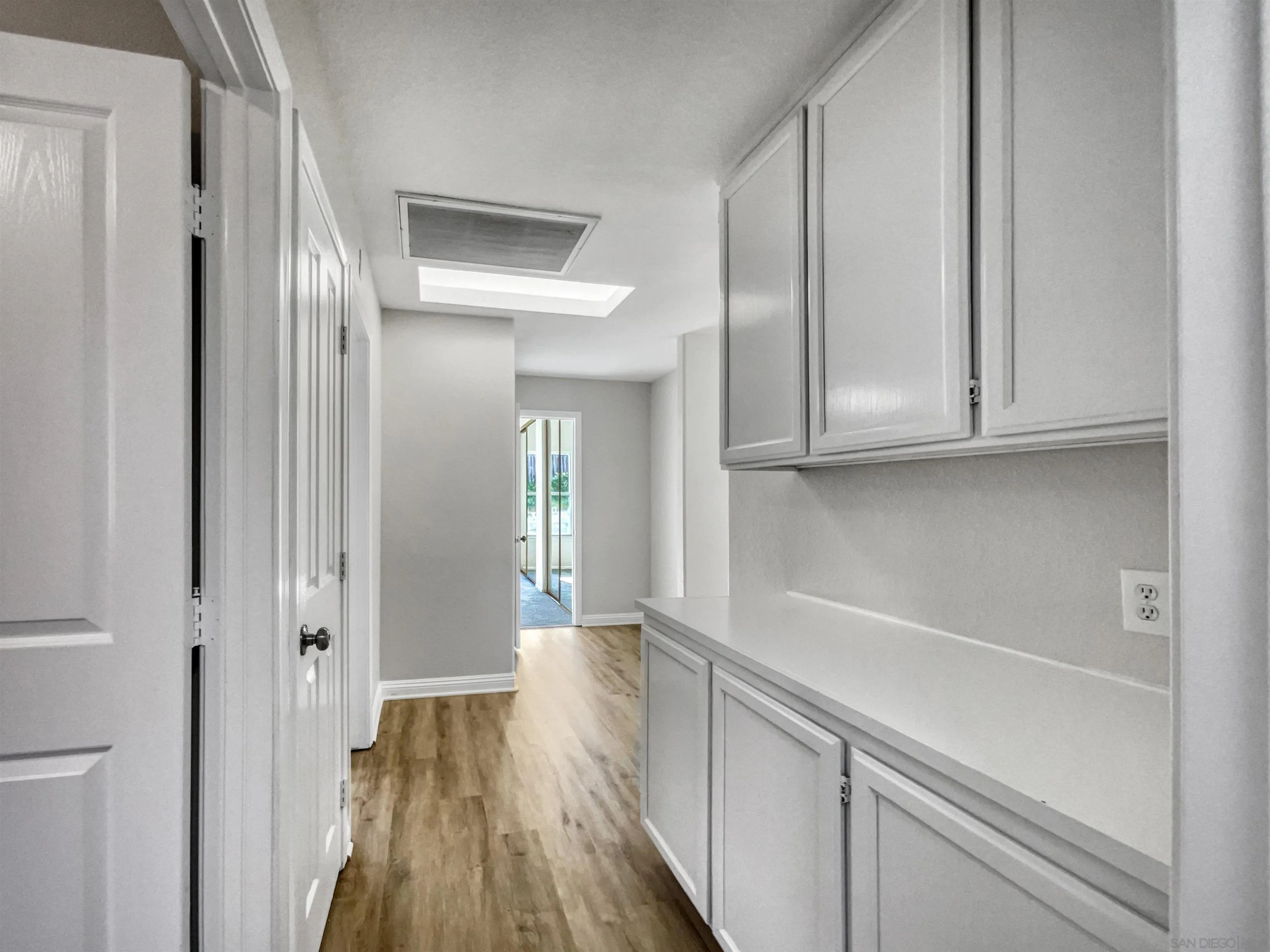 140 South Mercedes Road Fallbrook, CA 92028 - Photo 15 of 21 a view of a hallway with wooden floor and cabinets