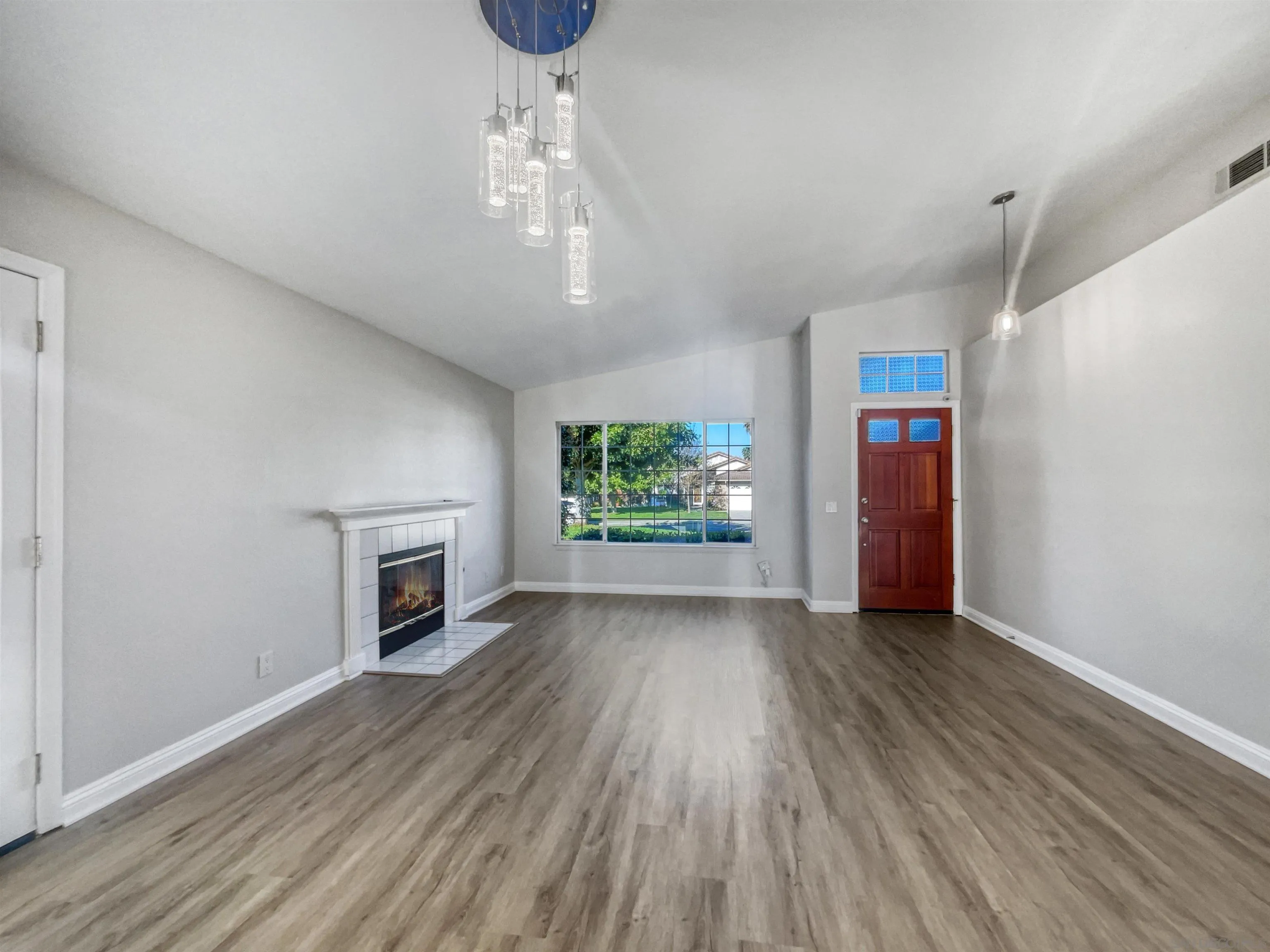 140 South Mercedes Road Fallbrook, CA 92028 - Photo 3 of 21 a view of empty room with wooden floor fireplace and window