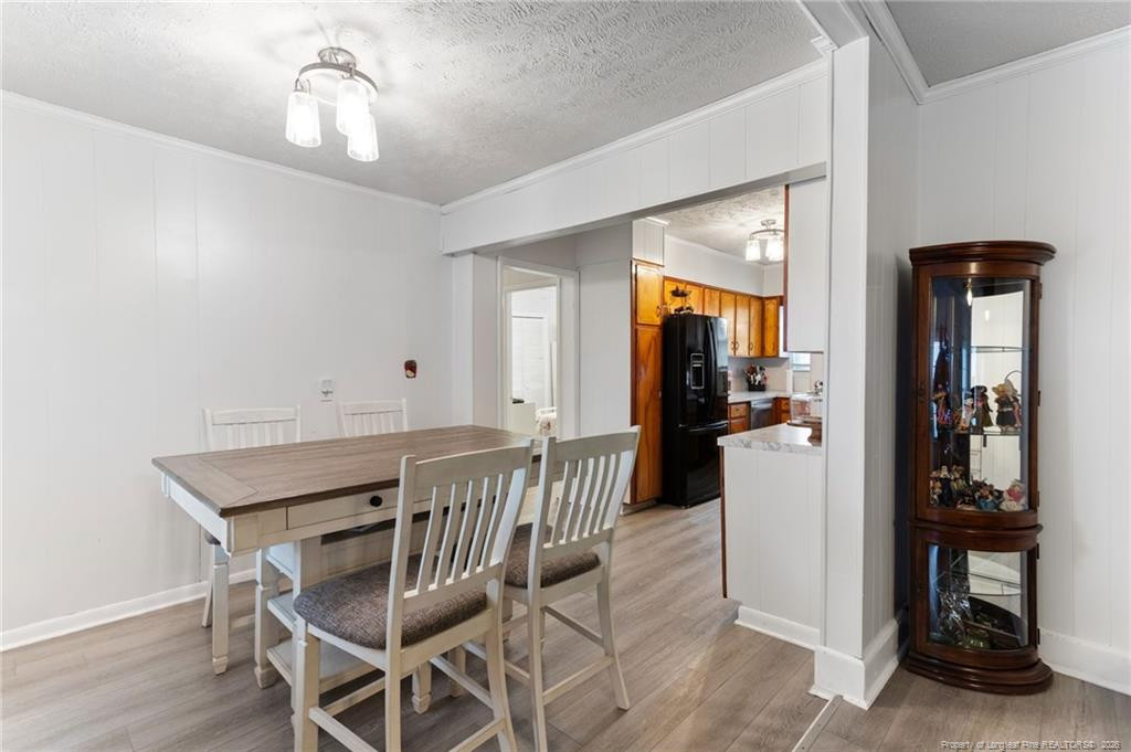 1069 Union Valley Road Whiteville, NC 28472 - Photo 12 of 50 a view of a dining room with furniture and wooden floor