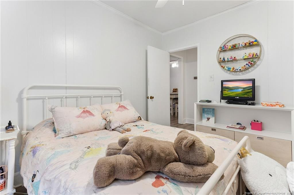 1069 Union Valley Road Whiteville, NC 28472 - Photo 16 of 50 a bedroom with a bed and a flat screen tv