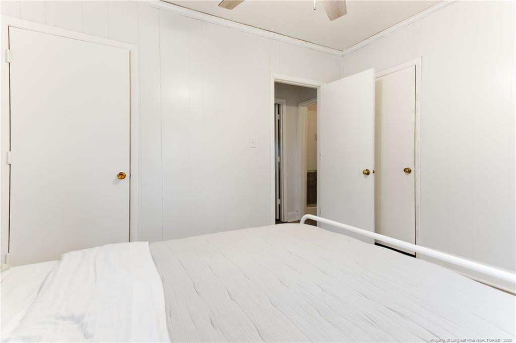 1069 Union Valley Road Whiteville, NC 28472 - Photo 20 of 50 a bedroom with a bed and a mirror