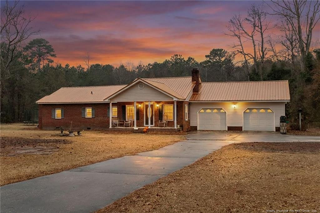 1069 Union Valley Road Whiteville, NC 28472 - Photo 2 of 50 a front view of a house with a yard and garage