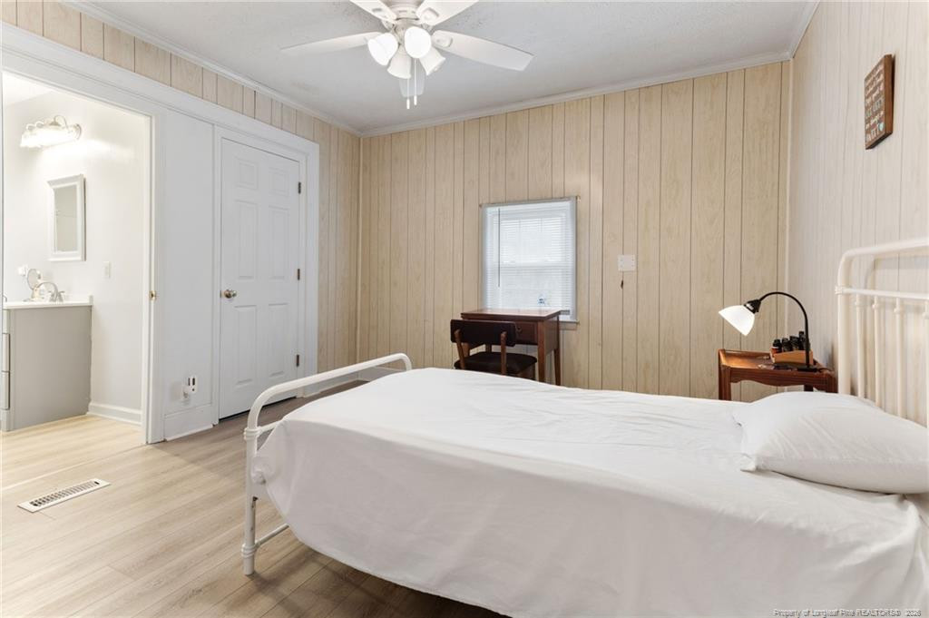 1069 Union Valley Road Whiteville, NC 28472 - Photo 21 of 50 a bedroom with a bed and a chandelier