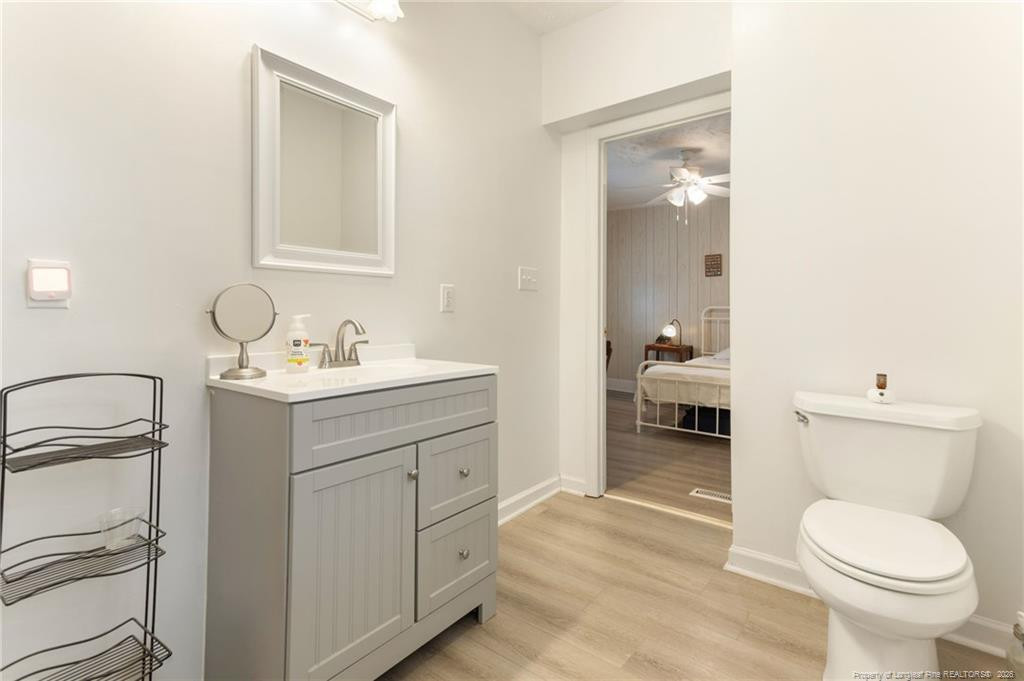 1069 Union Valley Road Whiteville, NC 28472 - Photo 23 of 50 a bathroom with a toilet sink and a mirror