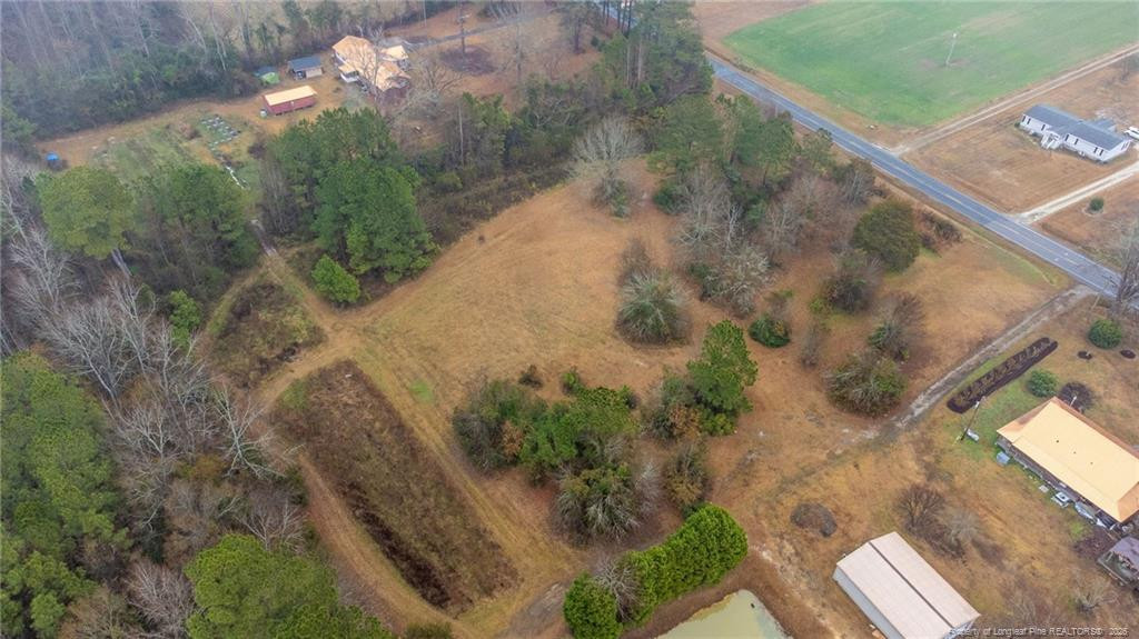 1069 Union Valley Road Whiteville, NC 28472 - Photo 39 of 50 a view of a yard with a wooden fence