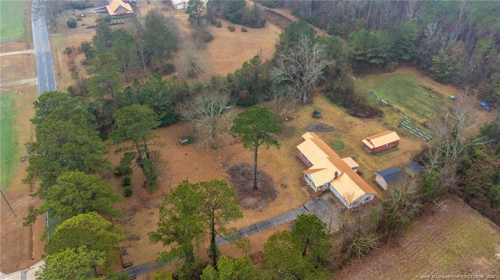 1069 Union Valley Road Whiteville, NC 28472 - Photo 47 of 50 an aerial view of a house a yard and a wooden fence