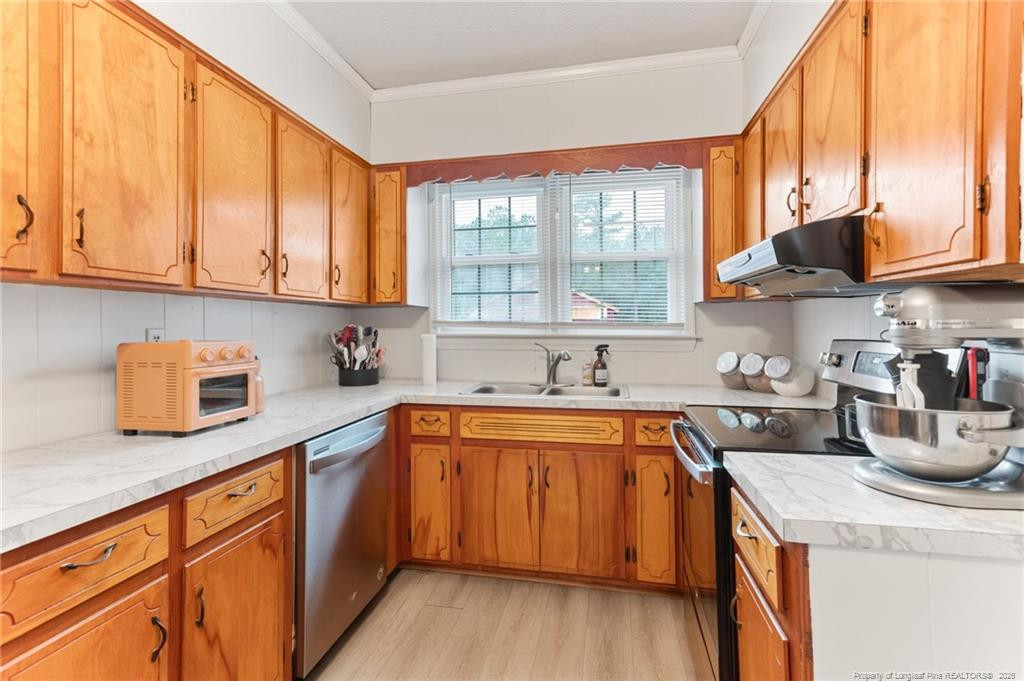 1069 Union Valley Road Whiteville, NC 28472 - Photo 10 of 50 a kitchen with stainless steel appliances granite countertop a sink a stove and a wooden cabinets