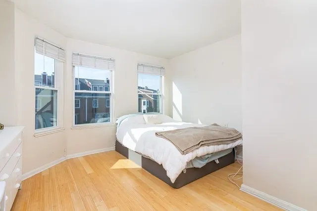 a spacious bedroom with a bed and window
