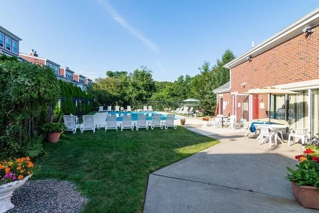 a view of a backyard with plants and outdoor seating
