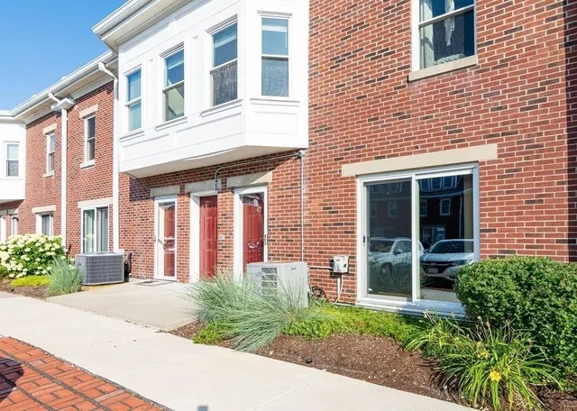 a view of a brick building next to a yard