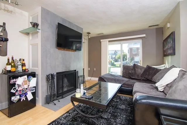 a living room with furniture fireplace and flat screen tv