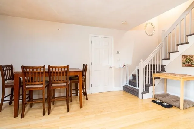 a dining room with furniture and a rug