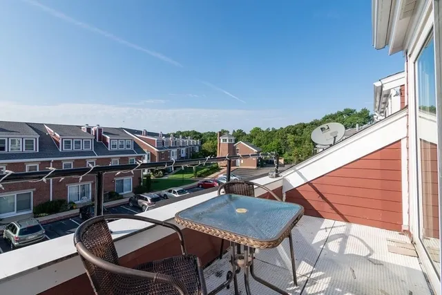 a balcony with table and chairs