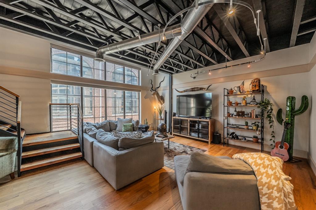 3911 Gilbert Avenue, Unit G Dallas, TX 75219 - Photo 12 of 35 a living room with furniture and a flat screen tv