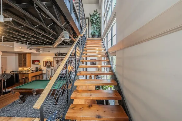 a view of staircase with wooden floor and a potted plant