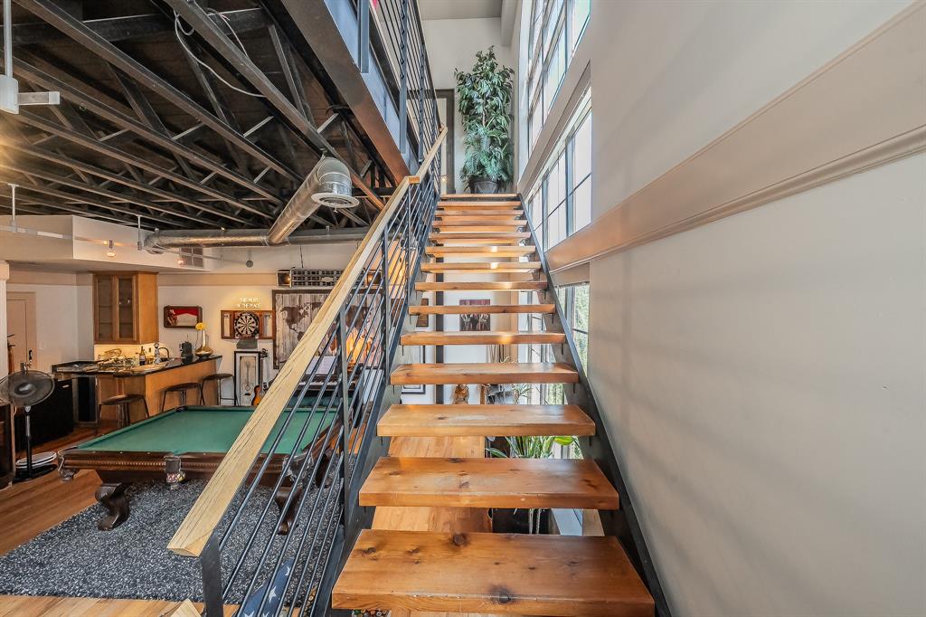 3911 Gilbert Avenue, Unit G Dallas, TX 75219 - Photo 18 of 35 a view of staircase with wooden floor and a potted plant