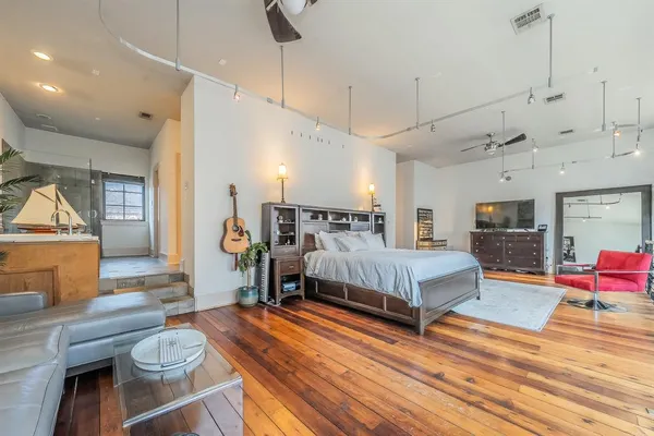 a bedroom with furniture and wooden floor
