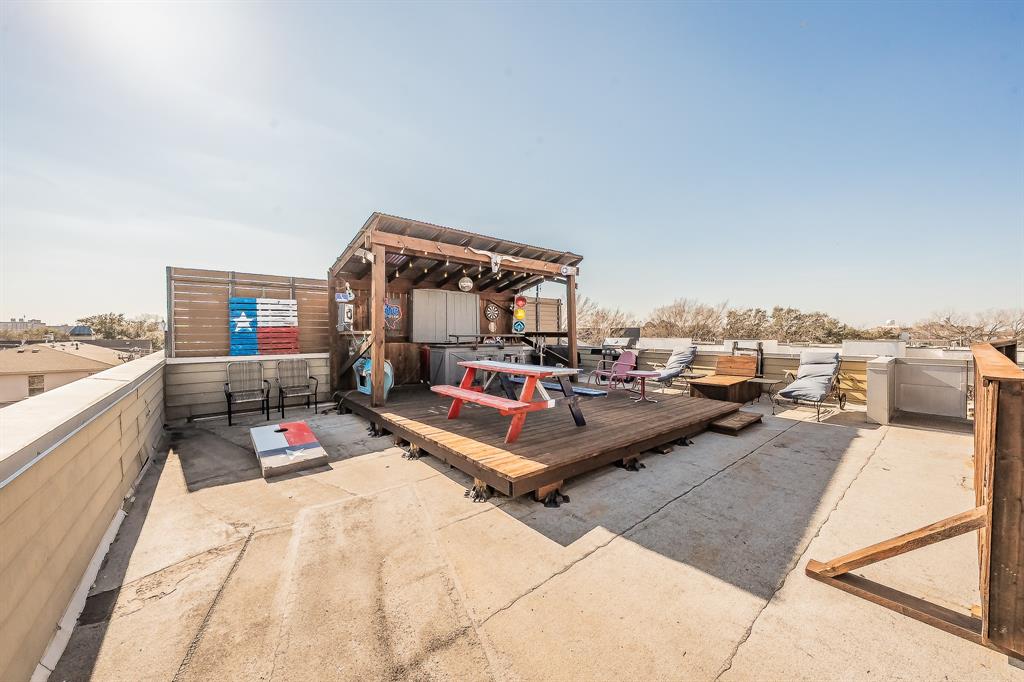 3911 Gilbert Avenue, Unit G Dallas, TX 75219 - Photo 2 of 35 a living room with furniture a rug and white walls