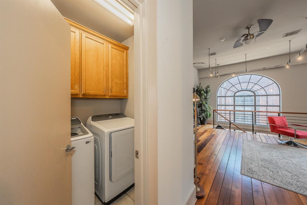 3911 Gilbert Avenue, Unit G Dallas, TX 75219 - Photo 23 of 35 a view of a hallway with wooden floor and furniture
