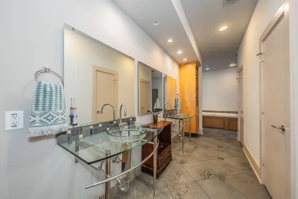 a dining hall with stainless steel appliances granite countertop a sink and cabinets