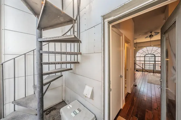 a view of staircase with railing and a window