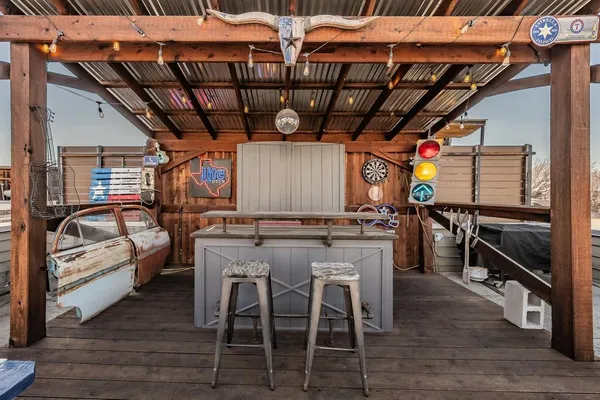 a view of a chairs and tables in the back yard of a house