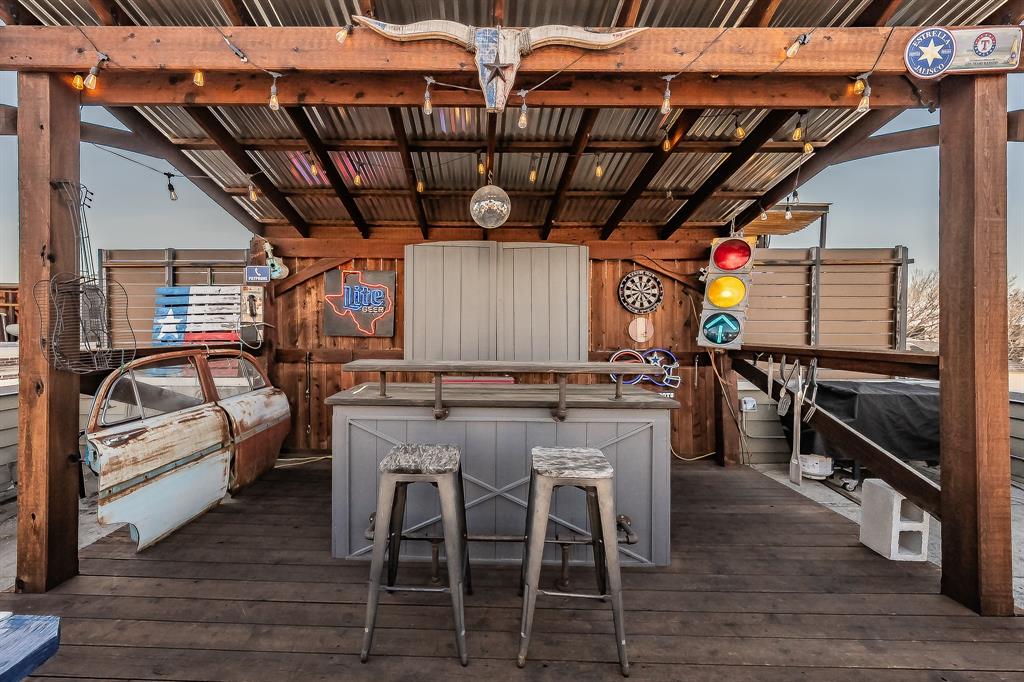 3911 Gilbert Avenue, Unit G Dallas, TX 75219 - Photo 3 of 35 a view of a chairs and tables in the back yard of a house