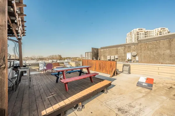 an outdoor sitting area with furniture and wooden floor