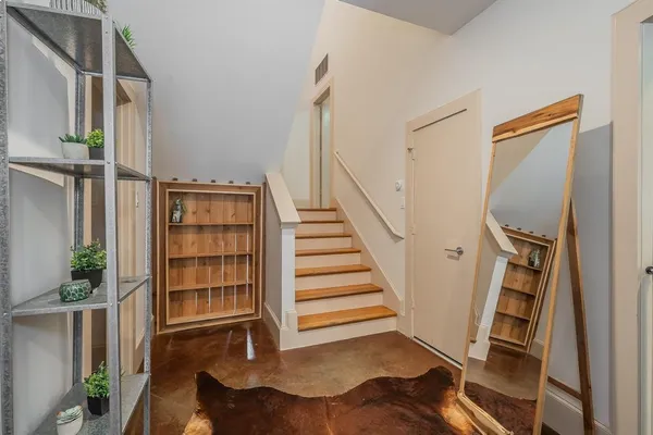 a view of a livingroom with furniture and staircase